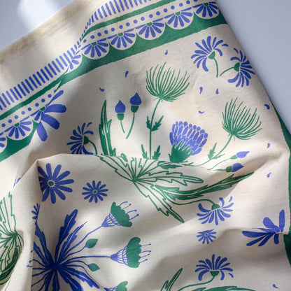 Floral patterned bandana with blue and green flowers on a white background