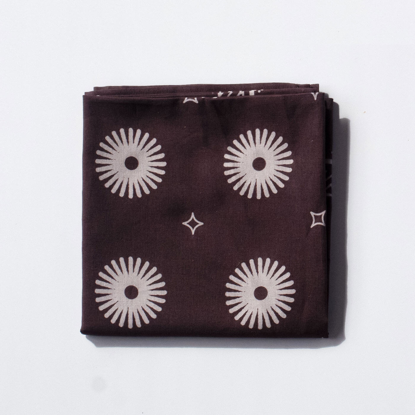 Purple bandana with white geometric patterns on a white background