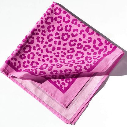 Pink scarf with leopard print pattern on a white background