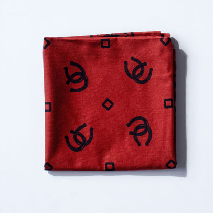 Red bandana with black geometric patterns on a white background