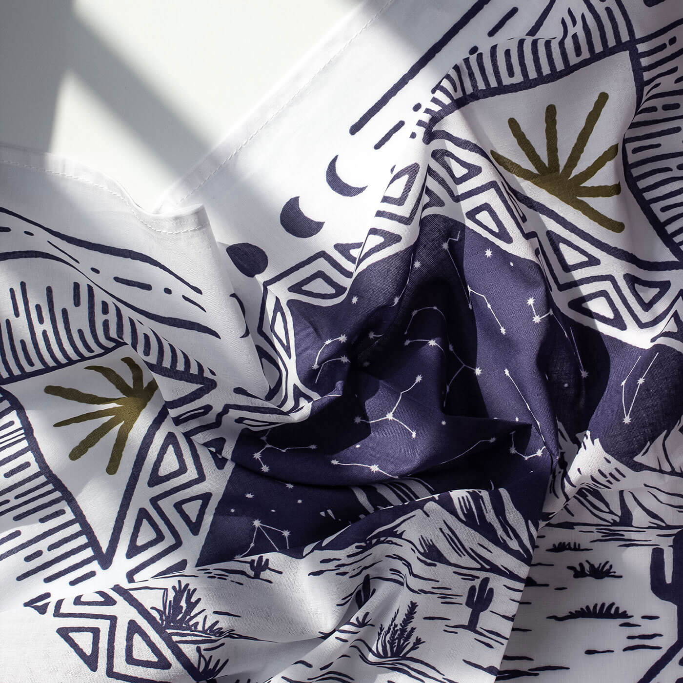 Bandana with abstract patterns including geometric shapes and celestial elements.