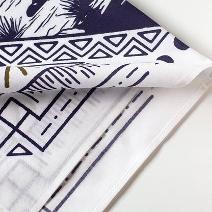 Close-up of patterned bandana with geometric and abstract designs on a white background